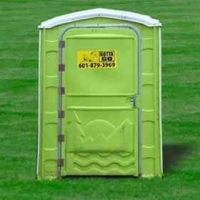 green handicap portable restroom on grassfield